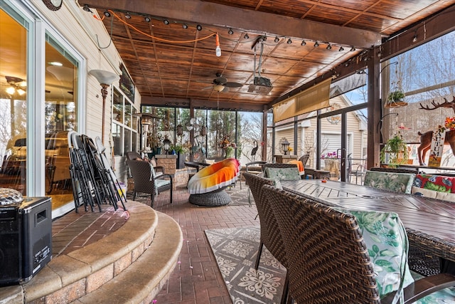 sunroom / solarium with ceiling fan and wood ceiling