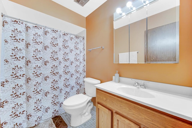 bathroom with tile patterned floors, vanity, and toilet