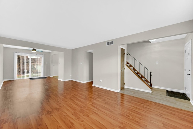 unfurnished living room featuring ceiling fan and light wood-type flooring