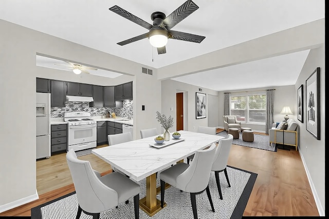 dining area with ceiling fan and light hardwood / wood-style floors