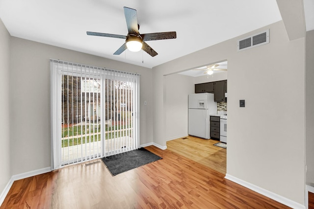 doorway to outside featuring ceiling fan and light wood-type flooring