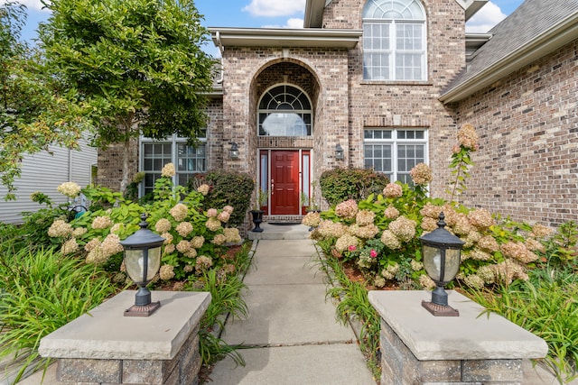 doorway to property with brick siding