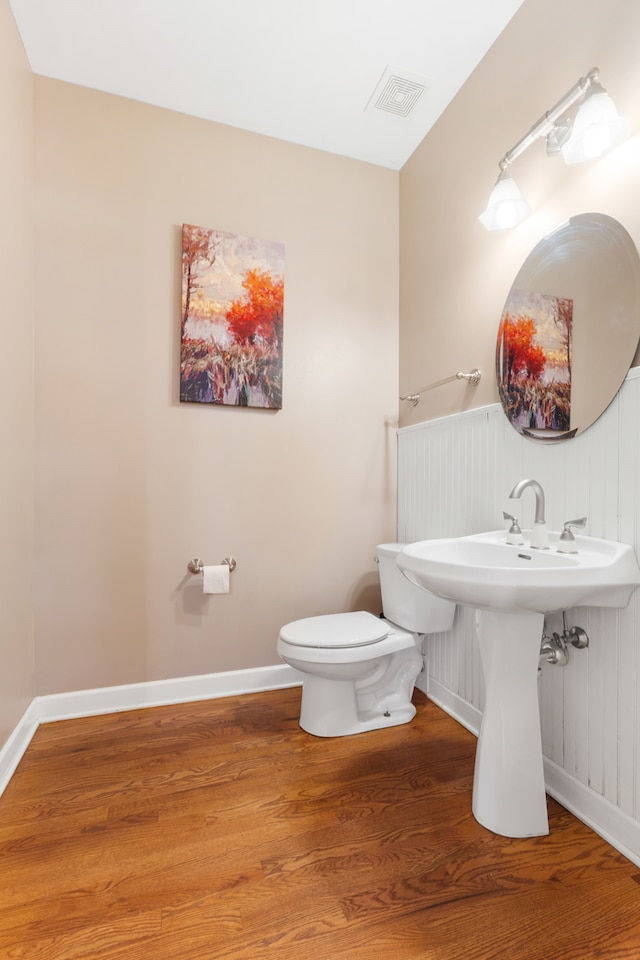 bathroom with sink, wood-type flooring, and toilet