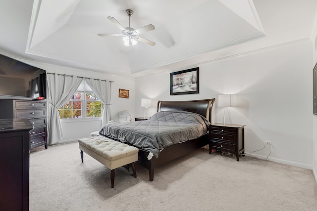 bedroom featuring baseboards, ceiling fan, a raised ceiling, and light colored carpet