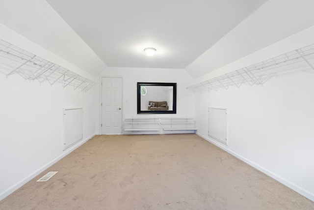 spacious closet featuring lofted ceiling, carpet, and visible vents