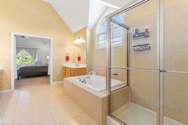 bathroom with tile patterned floors, vanity, vaulted ceiling, and separate shower and tub