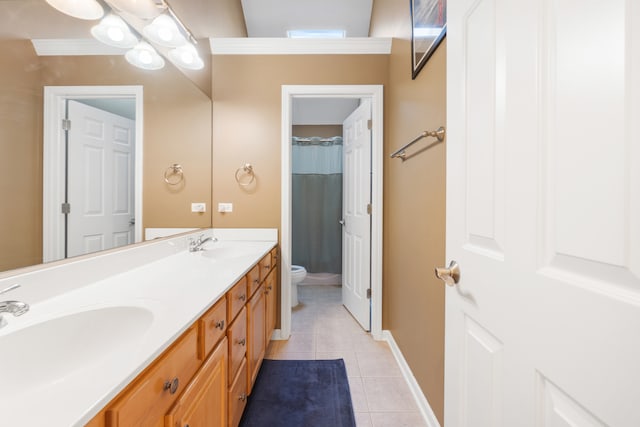 bathroom with tile patterned flooring, vanity, toilet, and crown molding