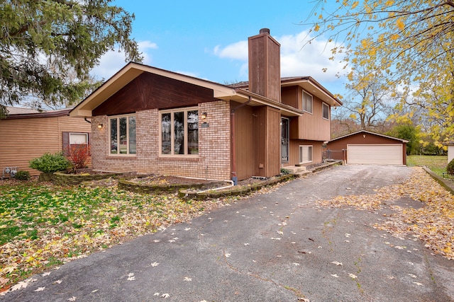 view of side of property featuring an outbuilding and a garage