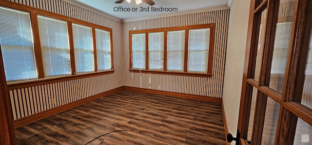 unfurnished sunroom with ceiling fan