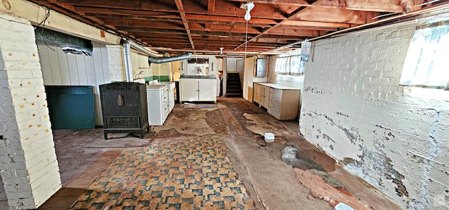 basement with electric panel and washer / dryer