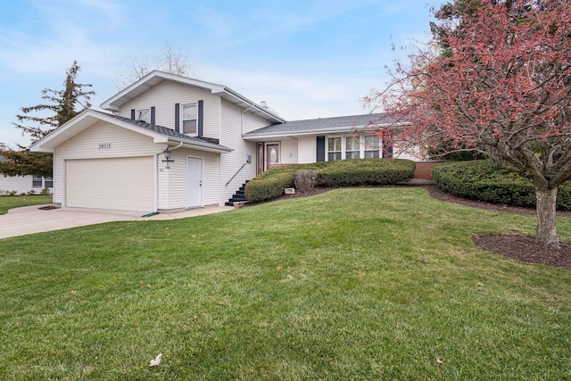 tri-level home with a garage and a front lawn