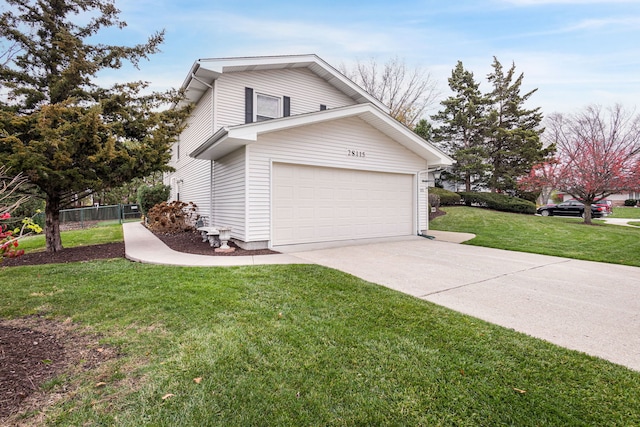 view of side of property featuring a yard and a garage