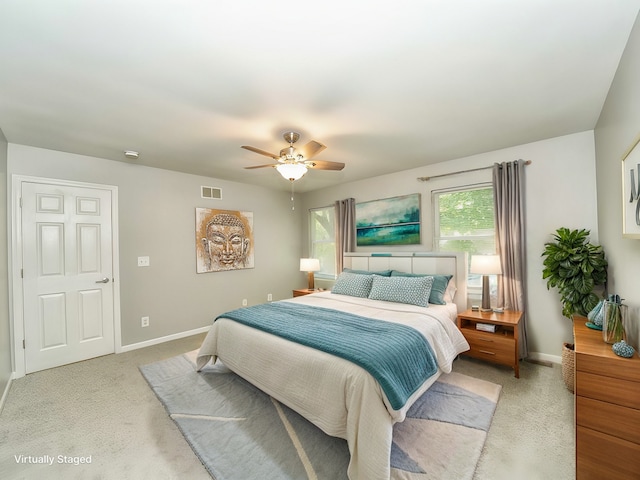 bedroom with light colored carpet and ceiling fan