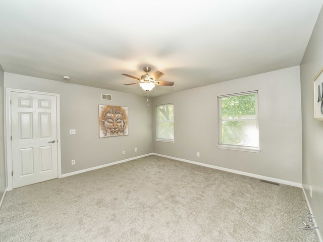 carpeted empty room featuring ceiling fan