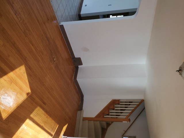 stairway with a towering ceiling and wood walls