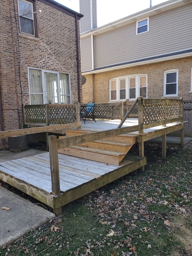 rear view of property with a wooden deck