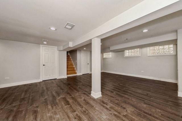 basement with dark hardwood / wood-style floors