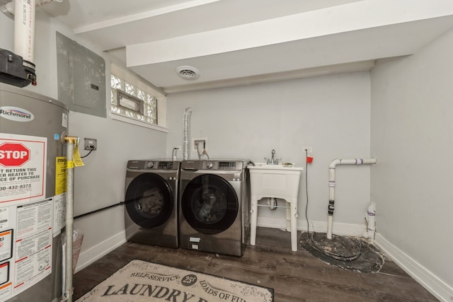 clothes washing area with electric panel, washer and clothes dryer, and gas water heater