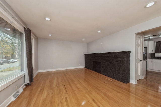 unfurnished living room with light wood-type flooring