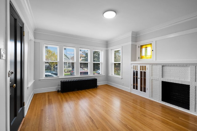 unfurnished sunroom featuring radiator, a wealth of natural light, and a fireplace