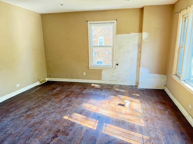 empty room featuring dark wood-type flooring