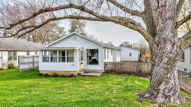 rear view of house with a lawn