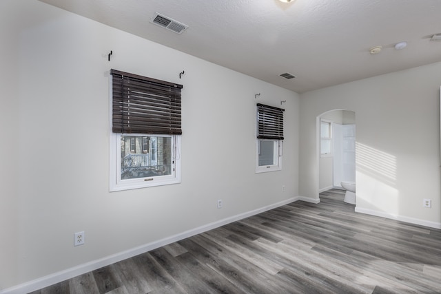 unfurnished room featuring hardwood / wood-style floors and a textured ceiling