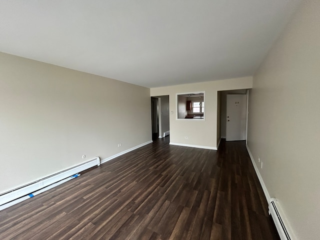 empty room featuring dark wood-type flooring and a baseboard radiator