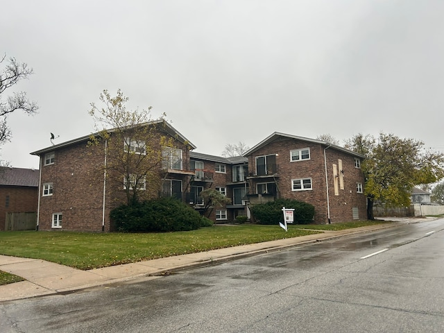 view of side of property with a lawn