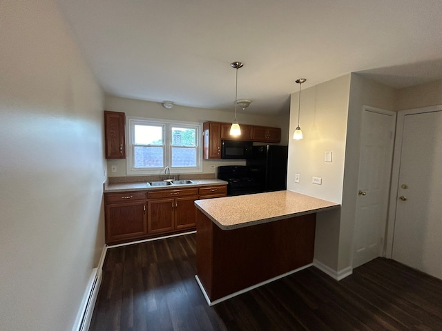 kitchen featuring black appliances, sink, dark hardwood / wood-style floors, decorative light fixtures, and kitchen peninsula