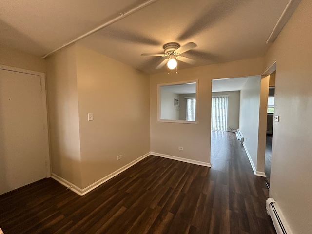 spare room with ceiling fan, dark wood-type flooring, a textured ceiling, and a baseboard heating unit