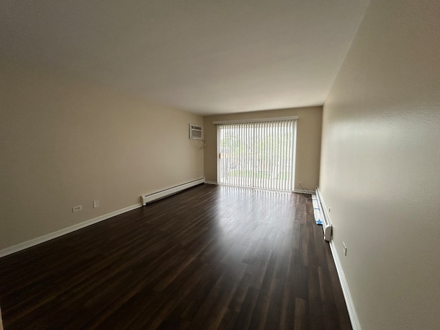 empty room featuring a wall mounted AC, dark wood-type flooring, and a baseboard radiator