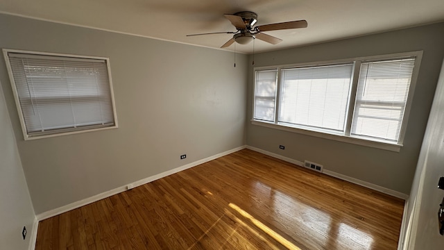 unfurnished room featuring ceiling fan and hardwood / wood-style floors