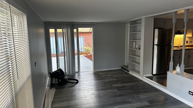 interior space with dark hardwood / wood-style floors, built in features, and sink