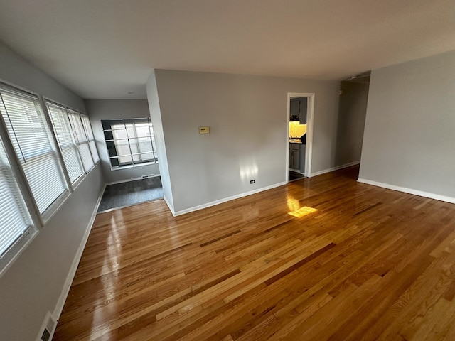 unfurnished room with wood-type flooring