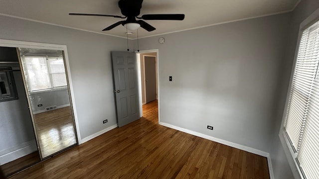 unfurnished bedroom with hardwood / wood-style floors, ceiling fan, and crown molding