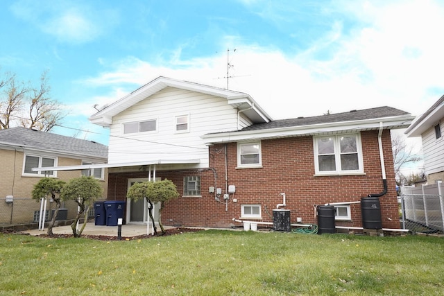 back of property with a patio area and a yard