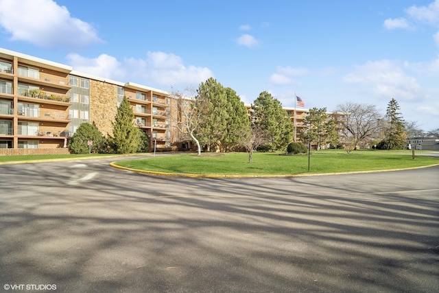 view of property's community with a lawn