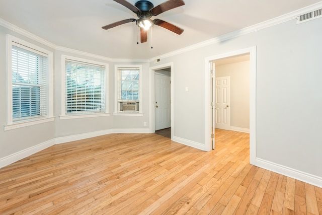 interior space with multiple windows, ceiling fan, crown molding, and light hardwood / wood-style floors