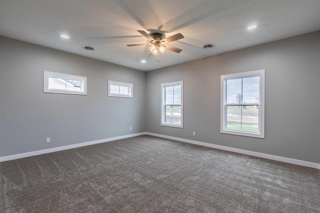 spare room with ceiling fan, carpet floors, and a textured ceiling