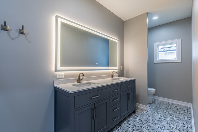 bathroom featuring vanity and toilet