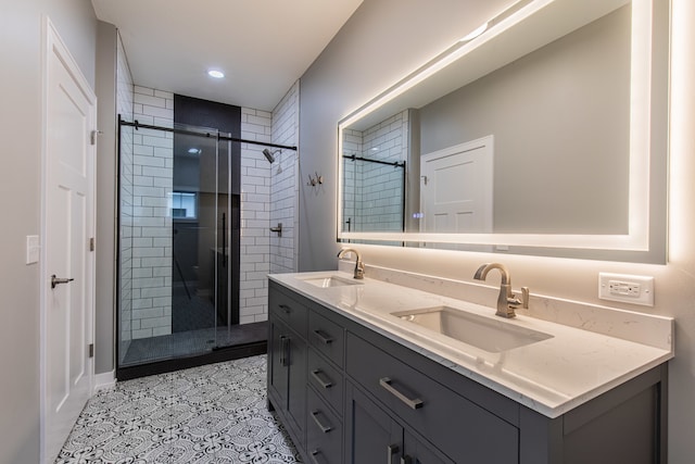 bathroom featuring tile patterned floors, a shower with door, and vanity