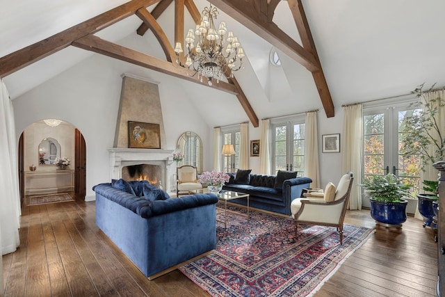 living room with french doors, dark wood-type flooring, beam ceiling, an inviting chandelier, and high vaulted ceiling