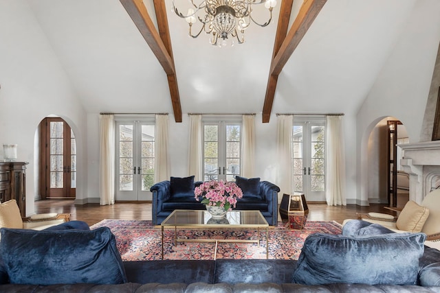 living room featuring a chandelier, french doors, beamed ceiling, and wood-type flooring