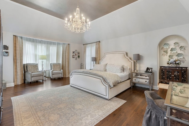 bedroom featuring a chandelier and dark wood-type flooring