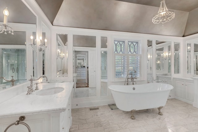 bathroom with high vaulted ceiling, a bathtub, and vanity