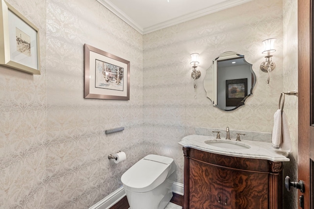 bathroom featuring toilet, vanity, and ornamental molding