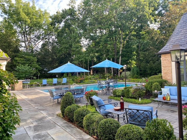 view of patio / terrace featuring outdoor lounge area and a community pool