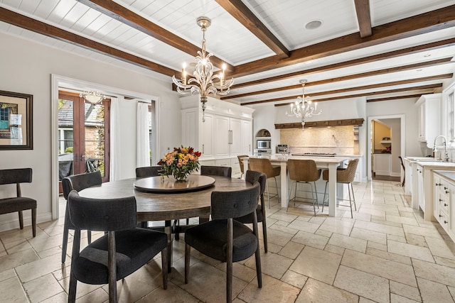 dining space with wood ceiling, sink, beamed ceiling, and a chandelier