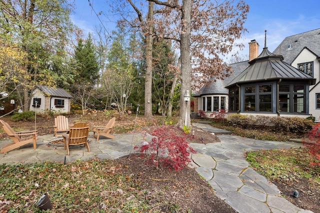 view of yard with an outdoor structure and a patio